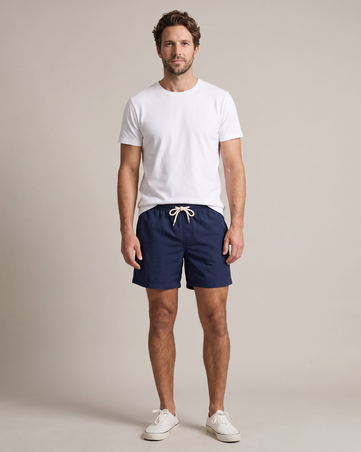 Bitcoin Swim Trunks Privacy in Navy Blue, worn, front view with tone-on-tone embroidered Bitcoin21 logo