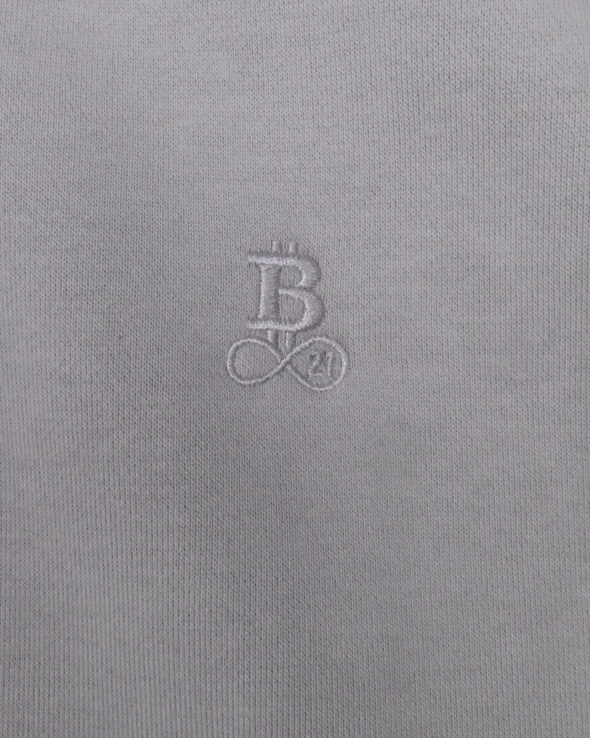 Bitcoin Oversized Hoodie Privacy in Light Grey, close-up of the tone-on-tone embroidered Bitcoin21 logo