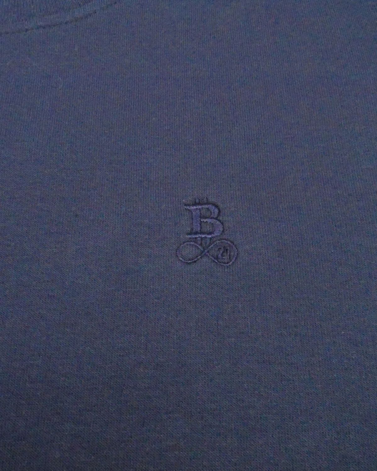 Bitcoin Sweatshirt Privacy in Navy, close-up of the tone-on-tone embroidered Bitcoin21 logo