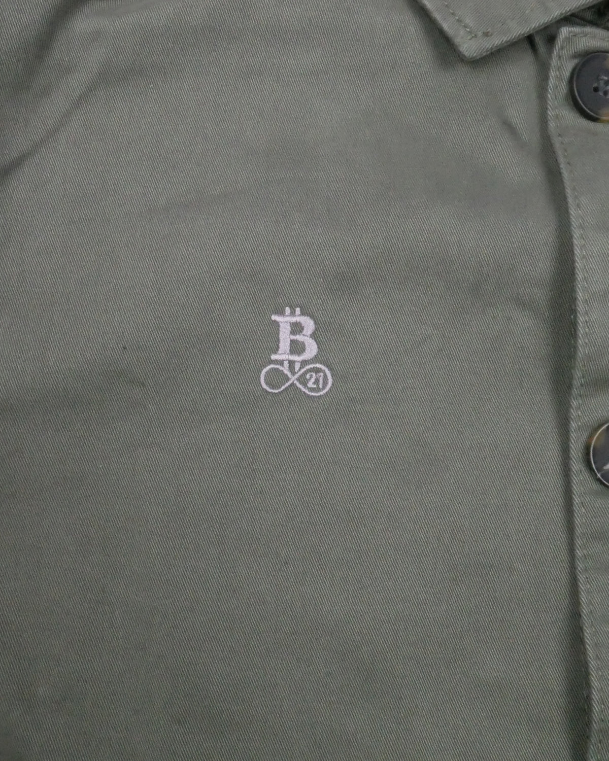 Bitcoin Worker Jacket Privacy in Washed Organic Khaki, close-up of the tone-on-tone embroidered Bitcoin21 logo