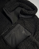 Bitcoin Sherpa Jacket Privacy in Black, detail of collar and chest pocket with tone-on-tone printed Bitcoin21 logo
