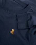 Bitcoin Sweatshirt navy für Herren aus schwerem Bio Baumwollmix, Detailaufnahme von Rundhalsausschnitt, Ärmelbündchen und gesticktem orangefarbenen Bitcoin21 Logo