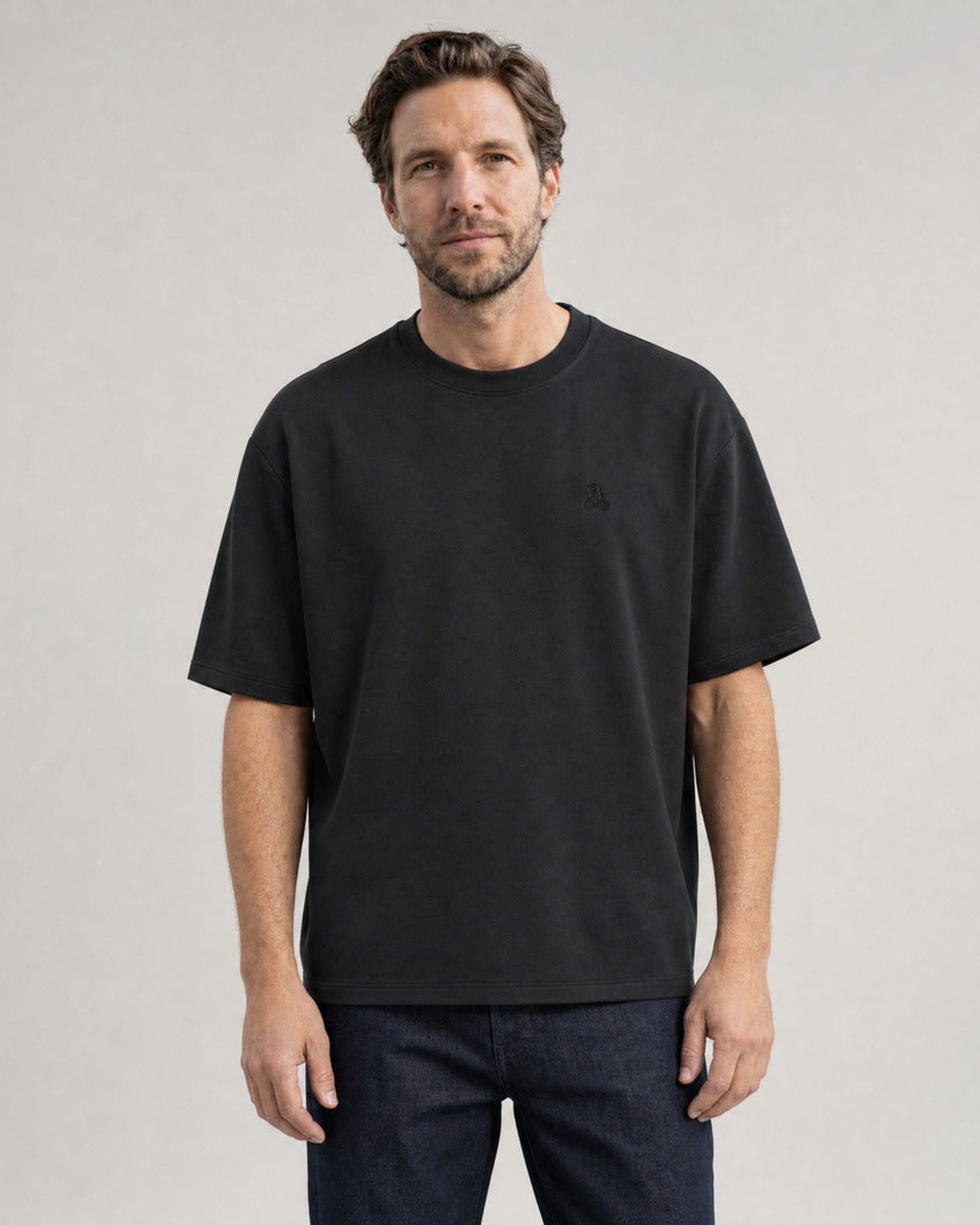 Homme portant le T-shirt oversize Bitcoin Privacy - Noir — logo Bitcoin21 brodé ton sur ton sur la poitrine, vue de face